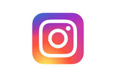Instagram logo. A square in sunset colors: purple, orange, red, and pink. In the middle of the colorful square is a white outline of a camera lens.