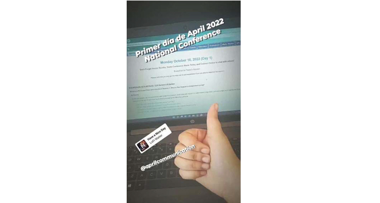 In image of a computer screen that shows the schedule for day 1 of the APRIL PreConference. A person's hand gesturing with a thumbs up signal shows at bottom of the screen.