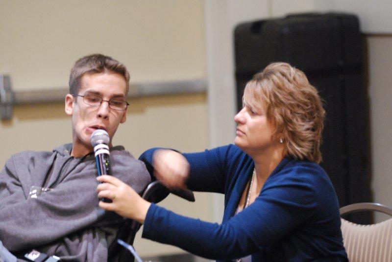 Women holding microphone for a man to speak into