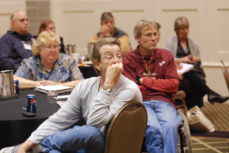 three people focused on a workshop discussion